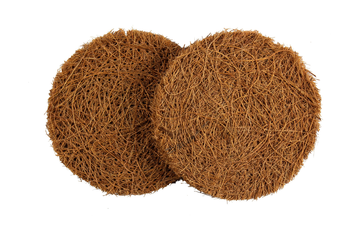 Two round coconut coir utensil and dish washing pads against a white background.