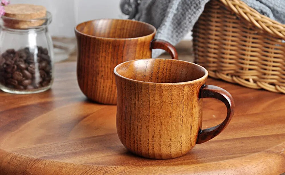 EcoNest 130ml Eco-Friendly Solid Wood Cup with Handle featuring tea inside on a rustic wooden table.