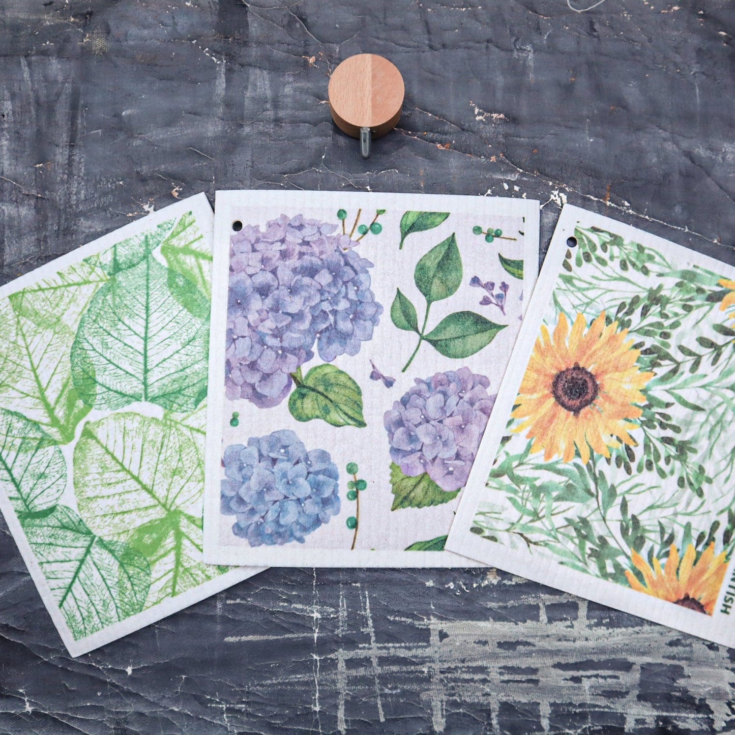 Three floral-themed cards on a textured surface