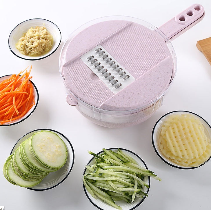 Pink mandoline slicer with sliced vegetables on a white background