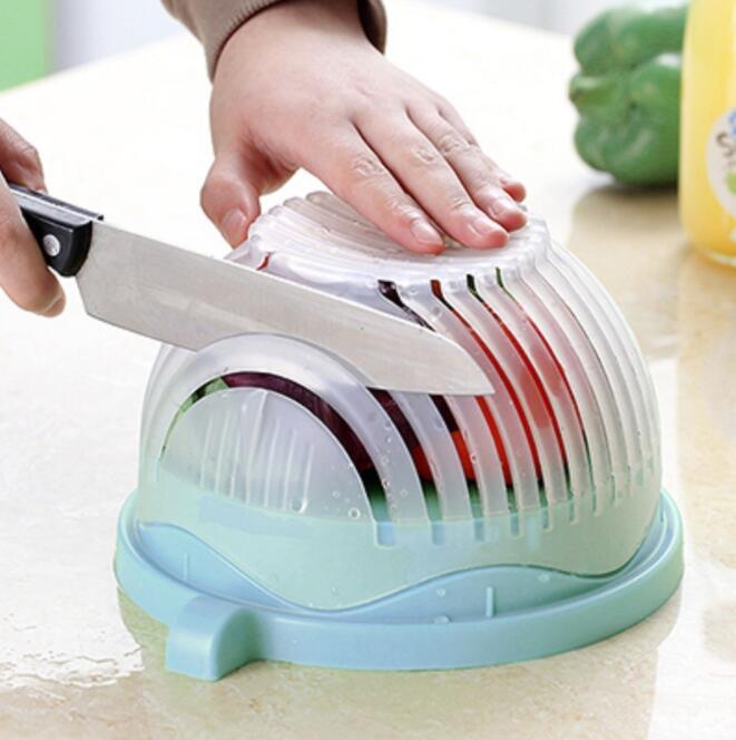 Person using a vegetable slicer to cut vegetables on a kitchen counter.