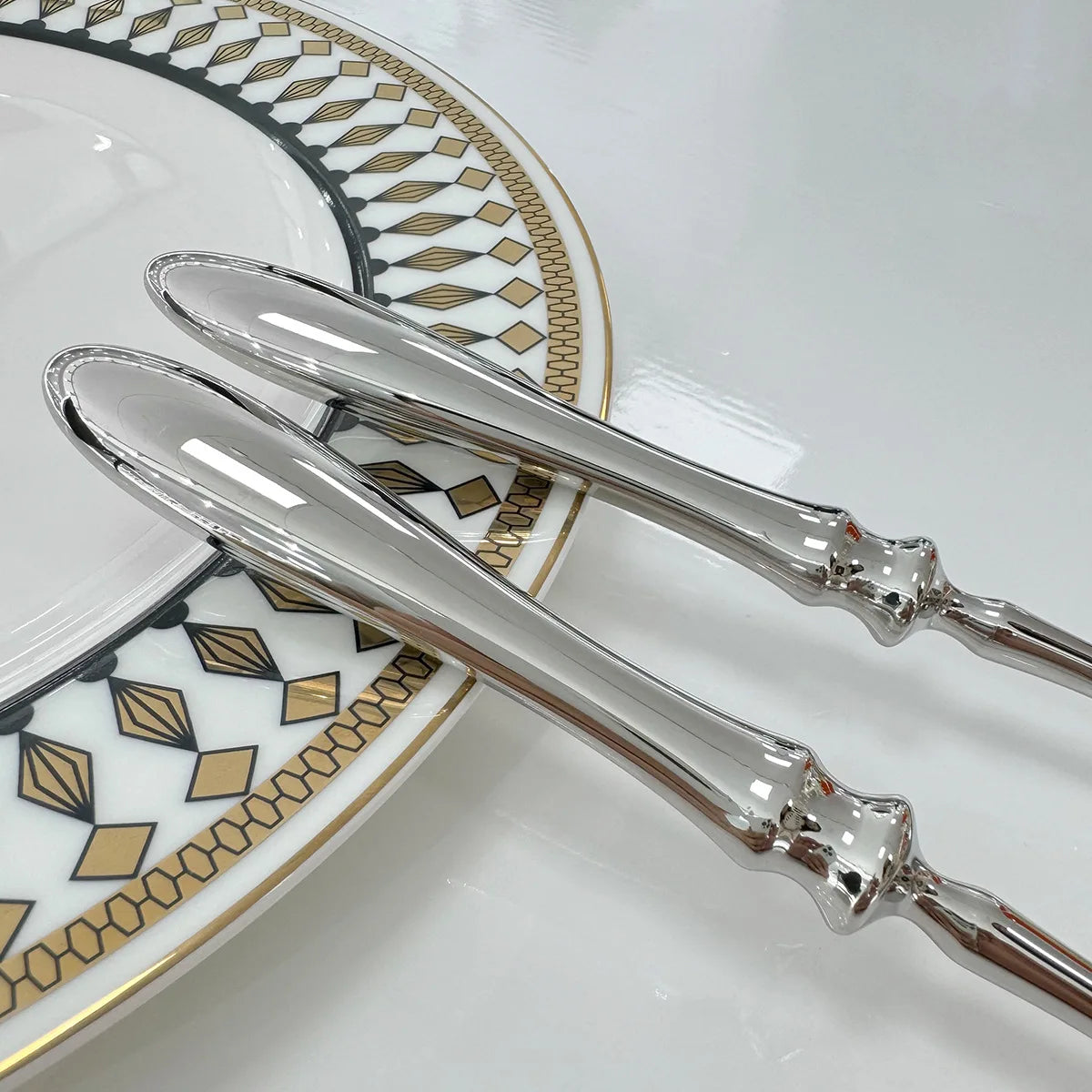 Stainless steel knife, fork, and spoon set by EcoNest Kitchen displayed on eco-conscious table setting