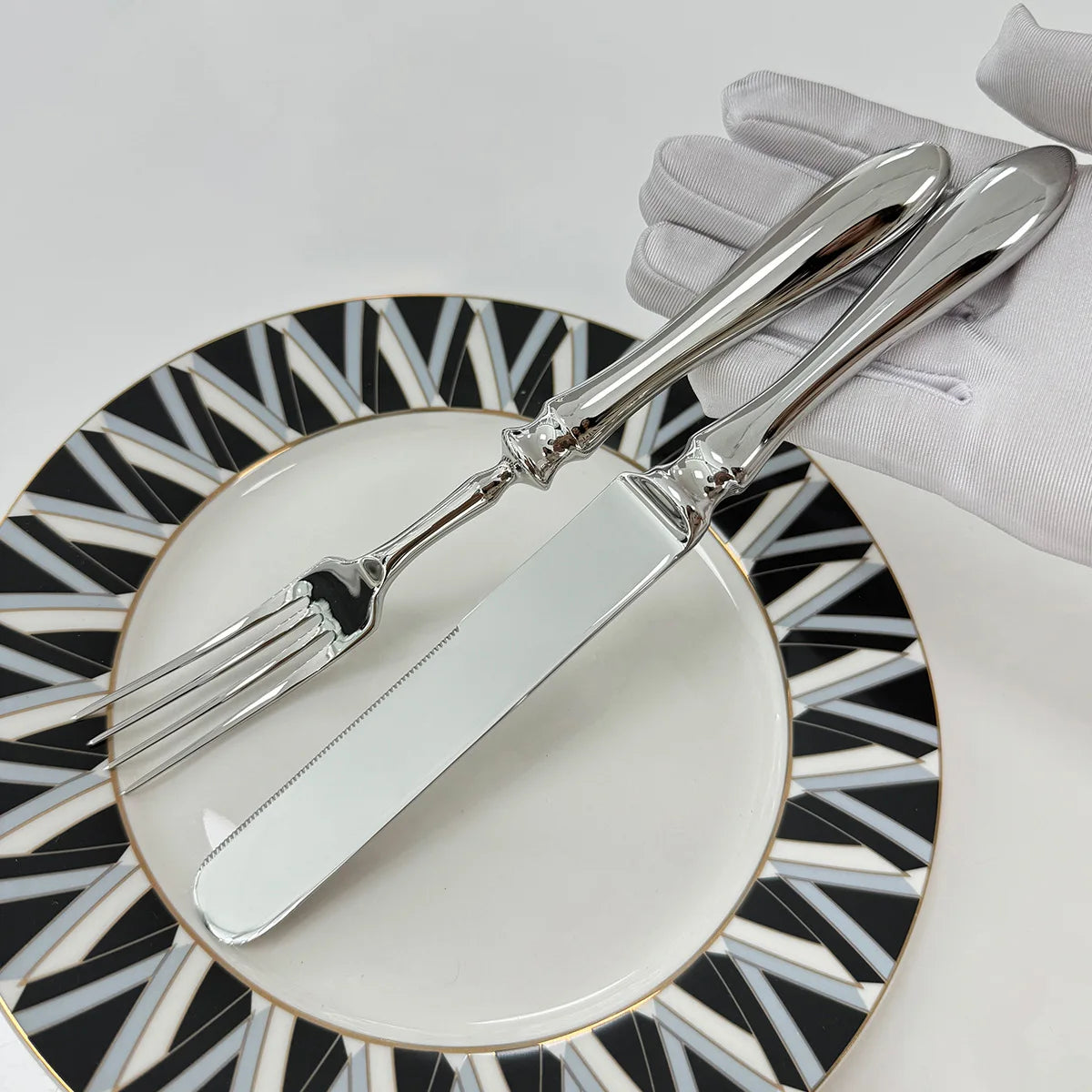 Stainless steel knife, fork, and spoon set by EcoNest Kitchen displayed on eco-conscious table setting