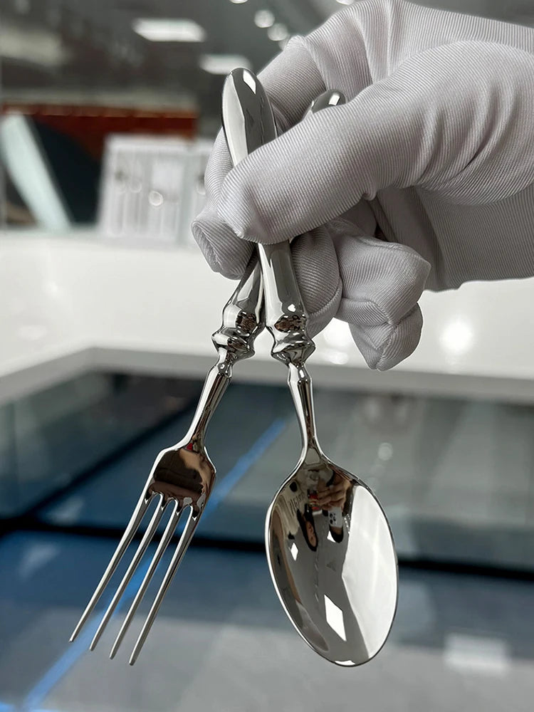 Stainless steel knife, fork, and spoon set by EcoNest Kitchen displayed on eco-conscious table setting