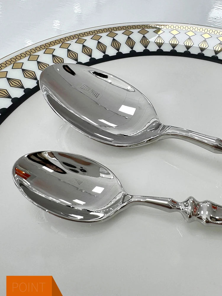 Stainless steel knife, fork, and spoon set by EcoNest Kitchen displayed on eco-conscious table setting