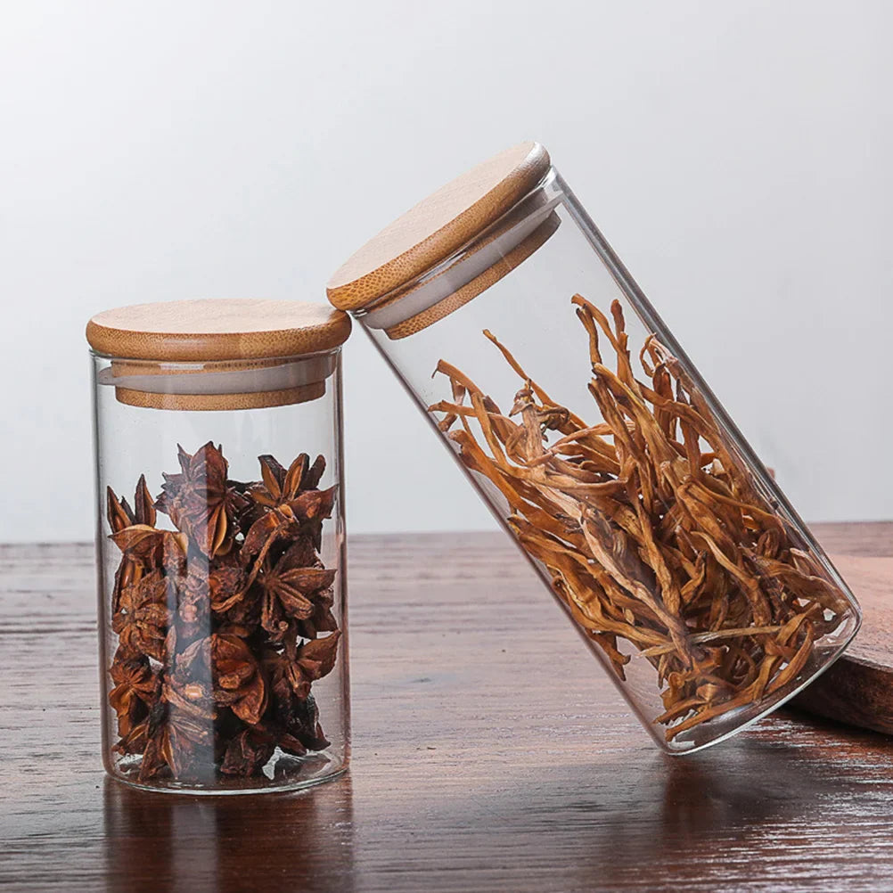 A collection of EcoNest Kitchen glass canisters with wooden lids, showcasing airtight seals for optimal food storage and organization.