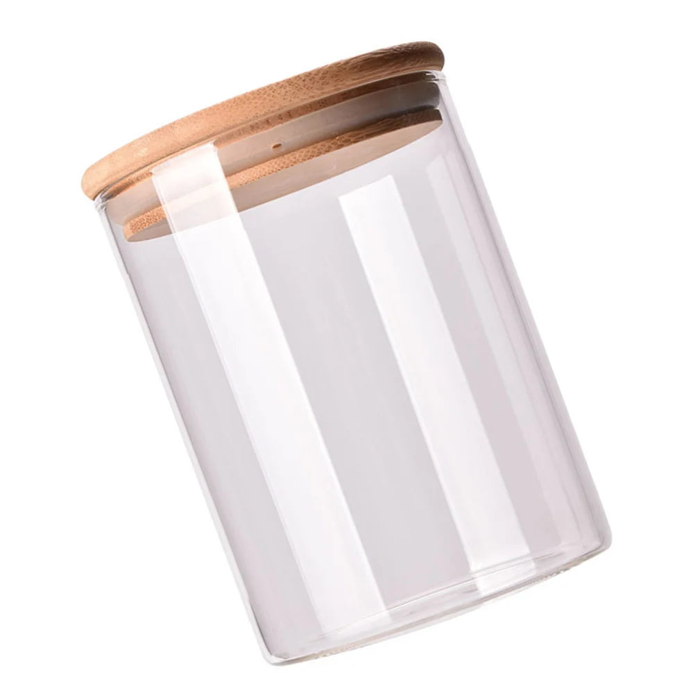 A collection of EcoNest Kitchen glass canisters with wooden lids, showcasing airtight seals for optimal food storage and organization.