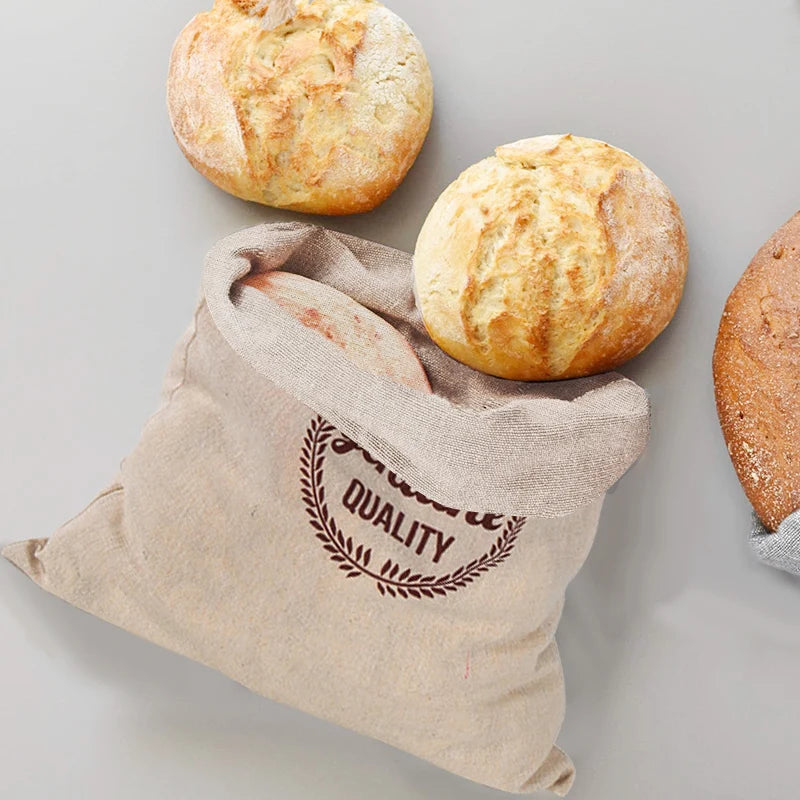 EcoNest reusable linen bread bag with drawstring, holding artisan bread on kitchen counter