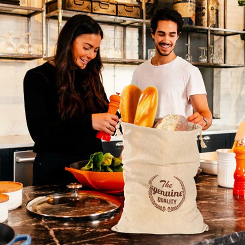 EcoNest reusable linen bread bag with drawstring, holding artisan bread on kitchen counter