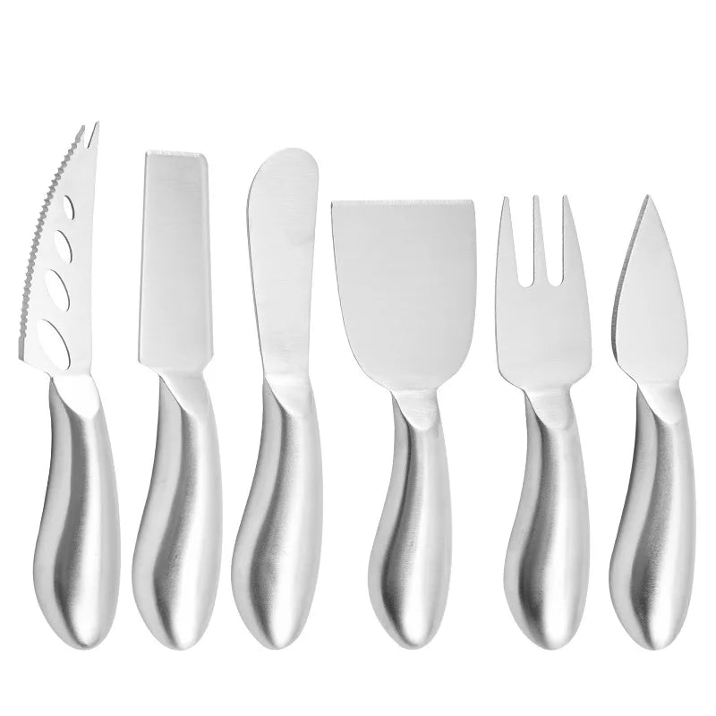 Set of silver cutlery including knives and a fork on a white background