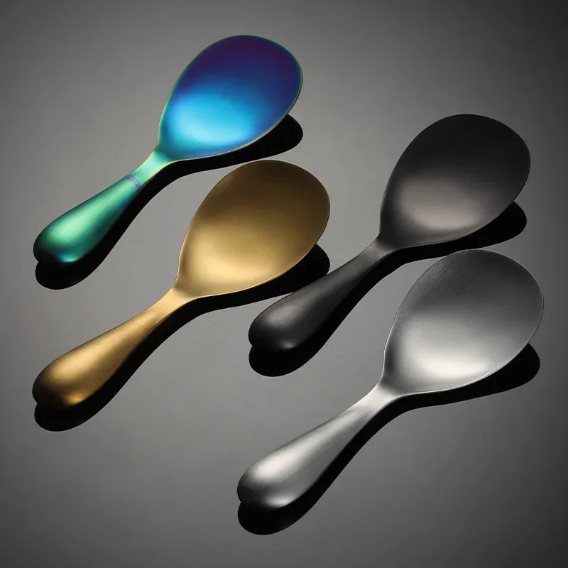 Four colorful spoons on a reflective surface with a dark background