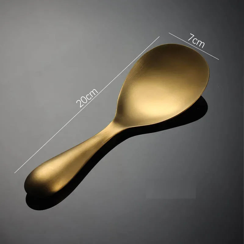 Gold spoon with measurements on a dark background