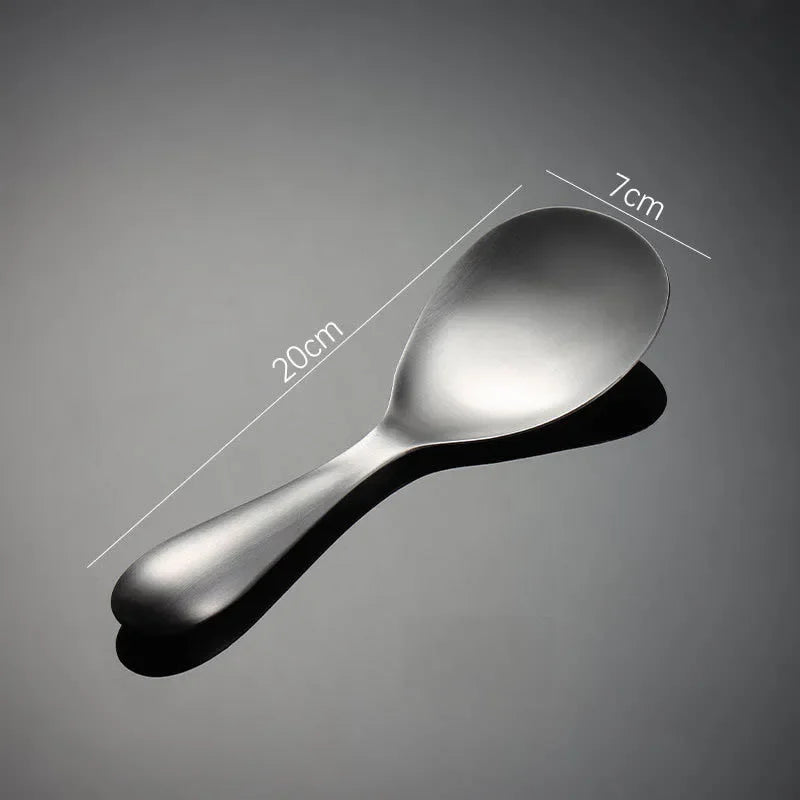 Stainless steel spoon with measurements on a gray background