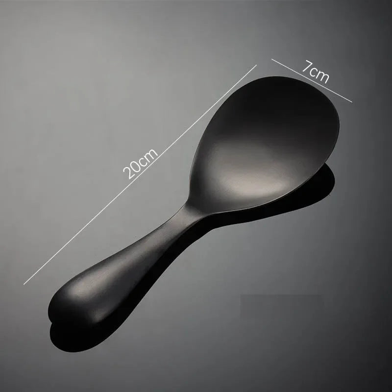 Black spoon with measurements on a gray background