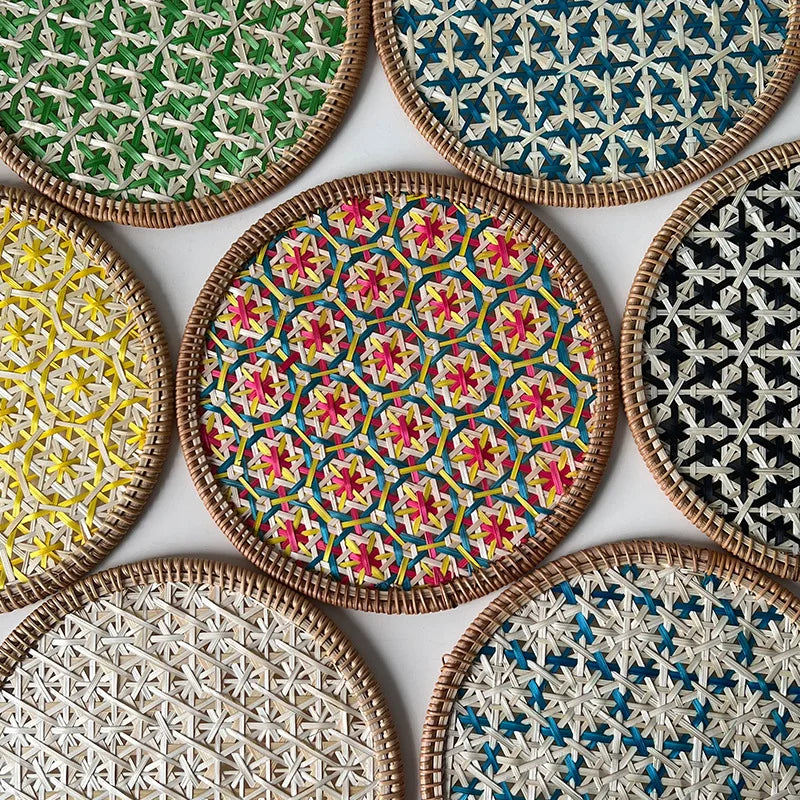 Collection of woven coasters with various geometric patterns on a white background
