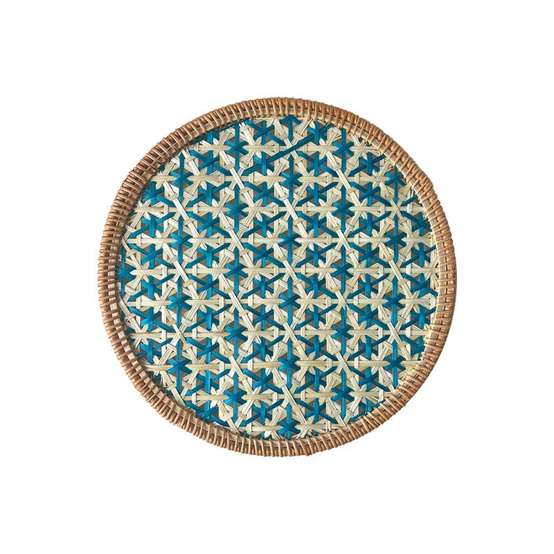 Round woven placemat with blue and beige pattern on a white background