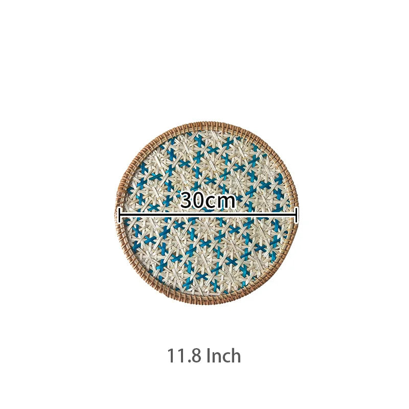Round woven mat with blue floral pattern and measurement text on a white background