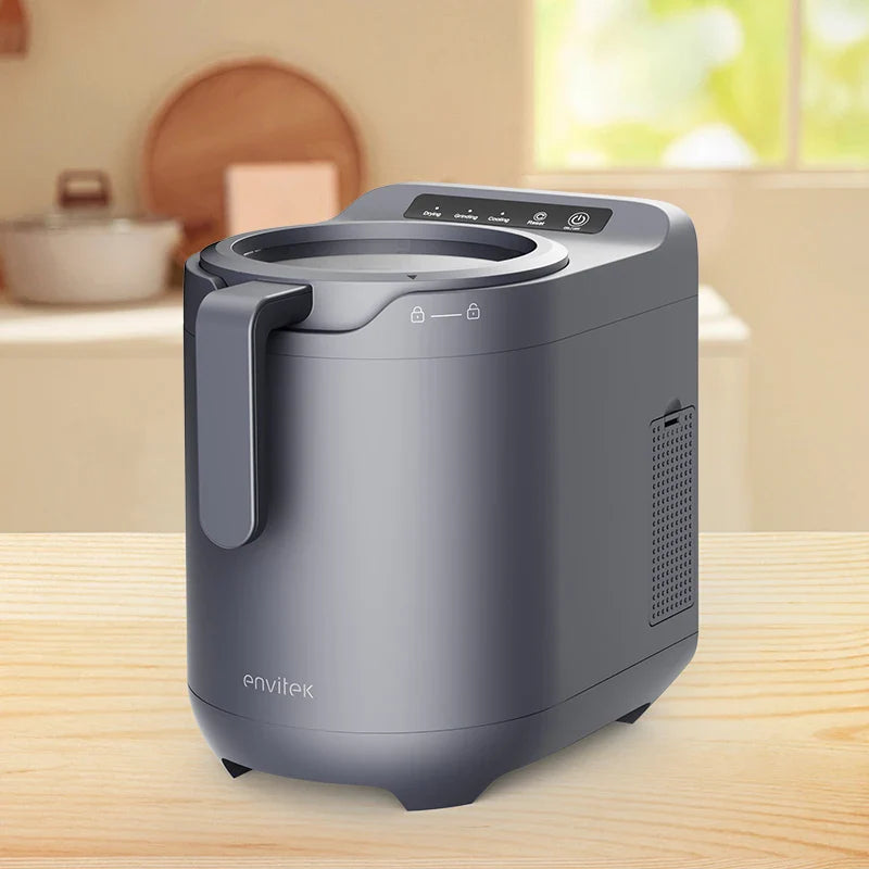 Envitek Recycle Food Machine in a modern kitchen setting, showcasing its sleek black design and stainless steel grinding chamber for effective food waste composting.