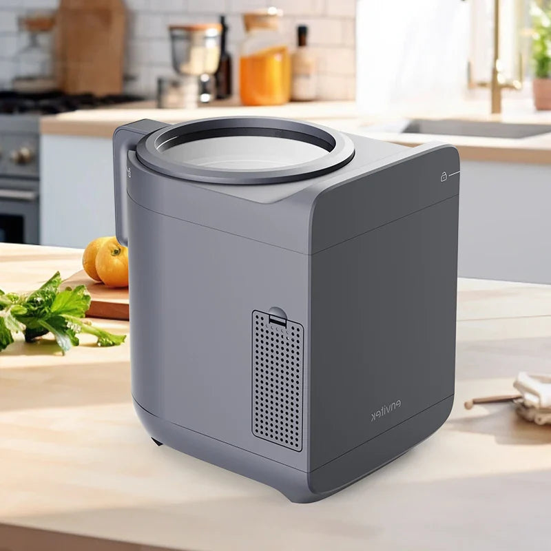 Envitek Recycle Food Machine in a modern kitchen setting, showcasing its sleek black design and stainless steel grinding chamber for effective food waste composting.