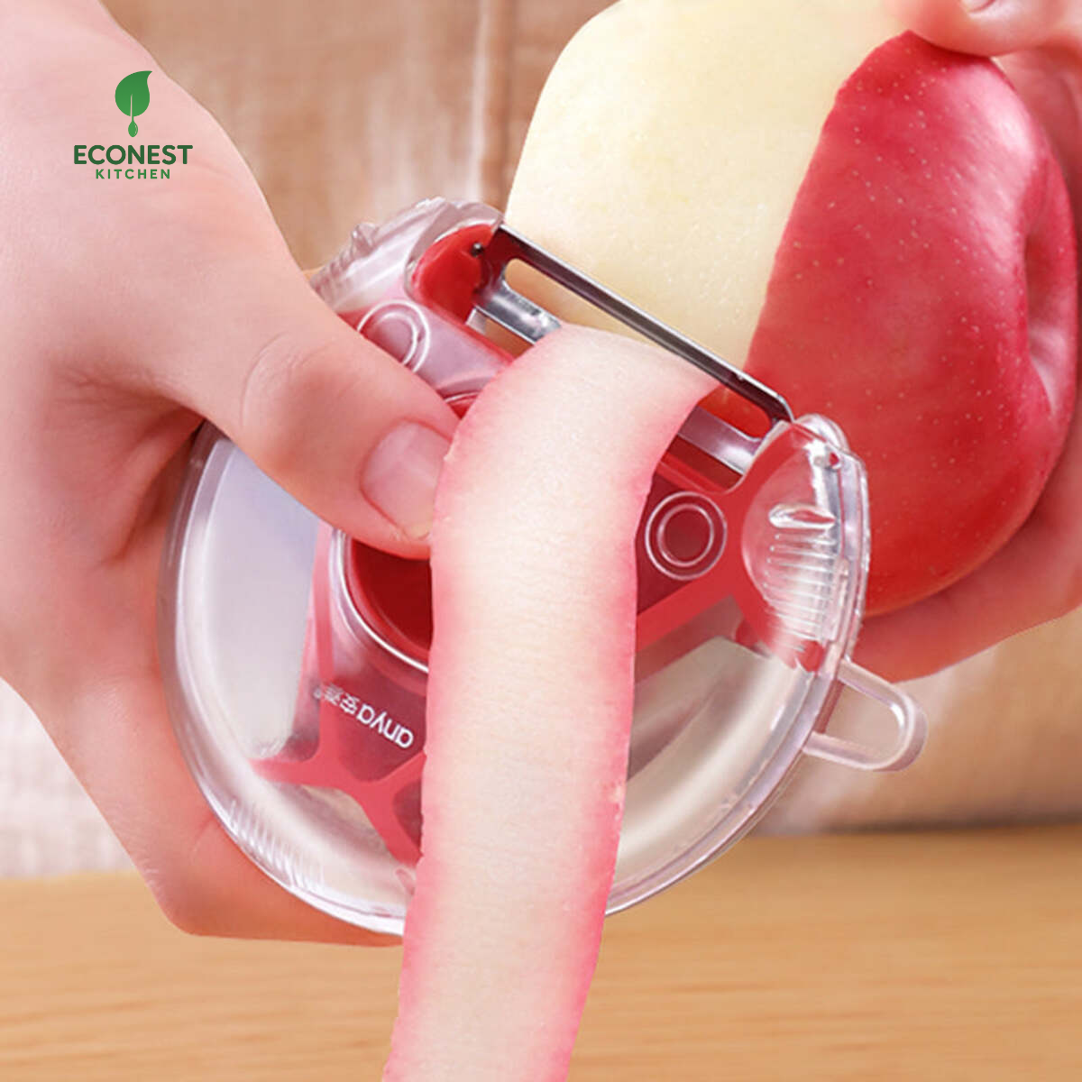 Person using a red and clear vegetable peeler on an apple with Econest Kitchen logo.