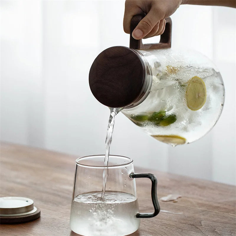 Large capacity 2000ML glass water jug with wooden handle and filter lid, heat-resistant and eco-friendly for hot or cold drinks.
