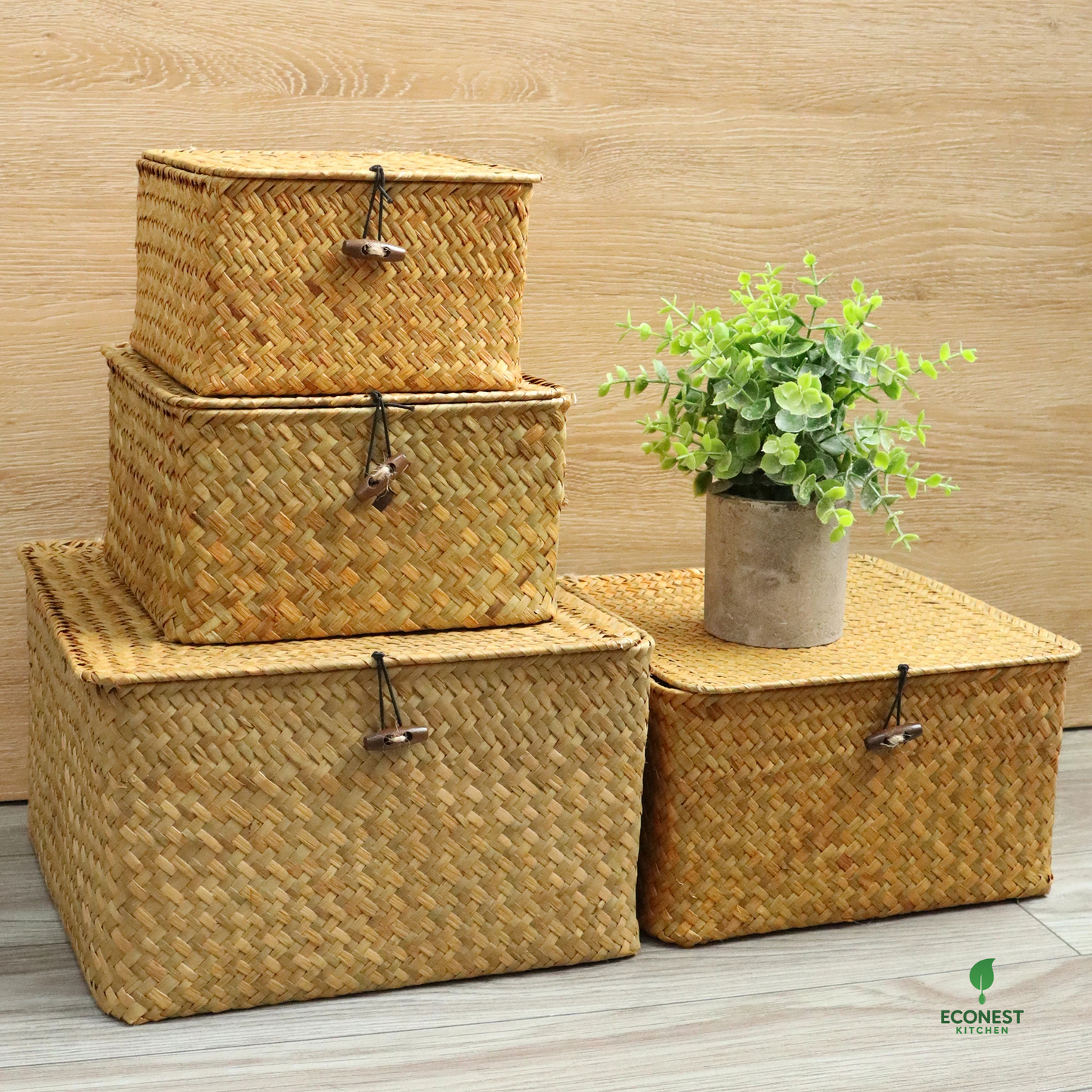 Set of woven storage baskets with a plant on a wooden floor, featuring the Econest brand.