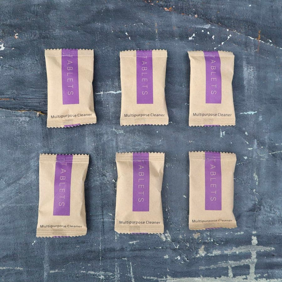 Six packages of 'Tablets' multivpurpose cleaner on a textured blue surface