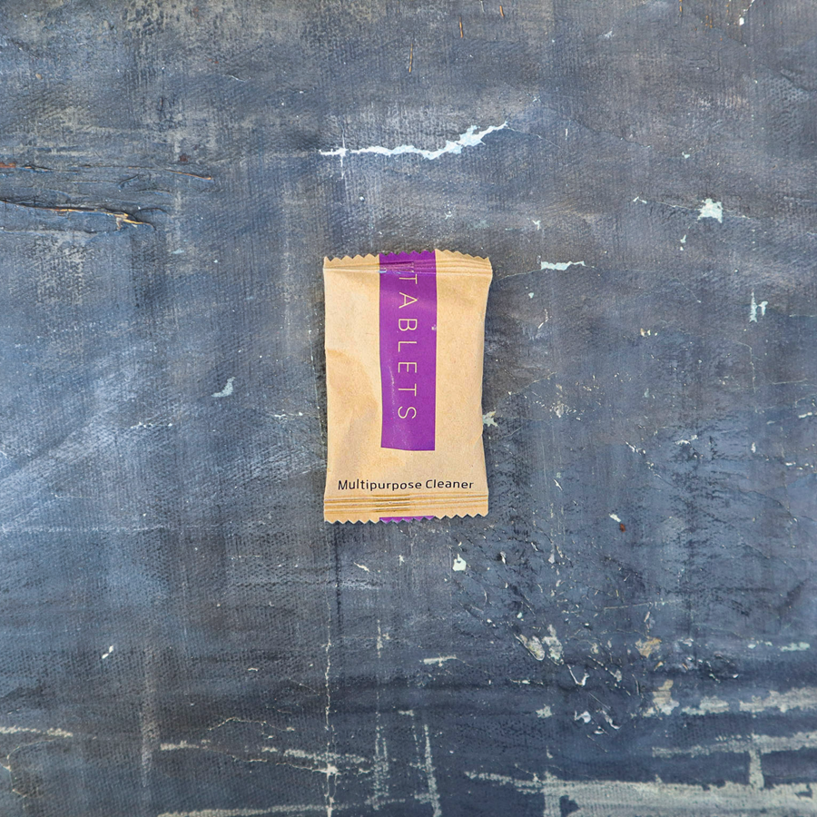 Package of tablets on a textured blue surface