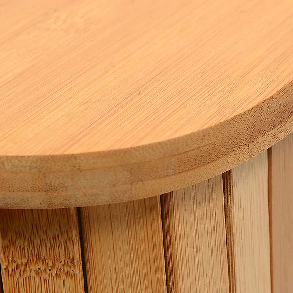 Close-up of a wooden stool with a round seat and vertical slats.