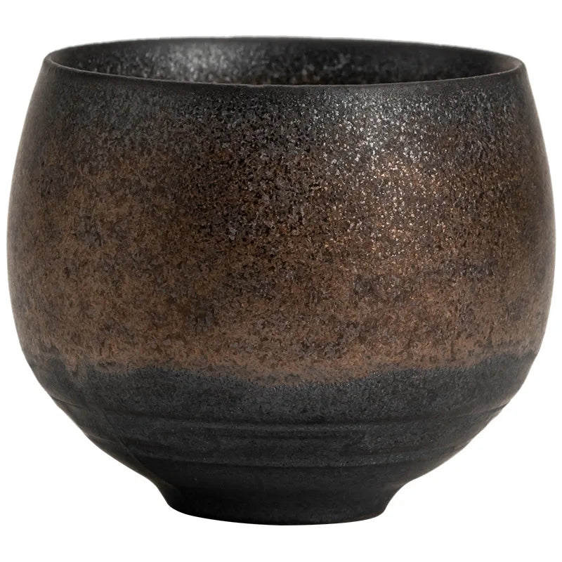 Black ceramic bowl with a textured surface on a white background