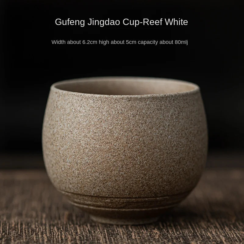 Ceramic cup labeled 'Gufeng Jingdao Cup-Reef White' on a dark background