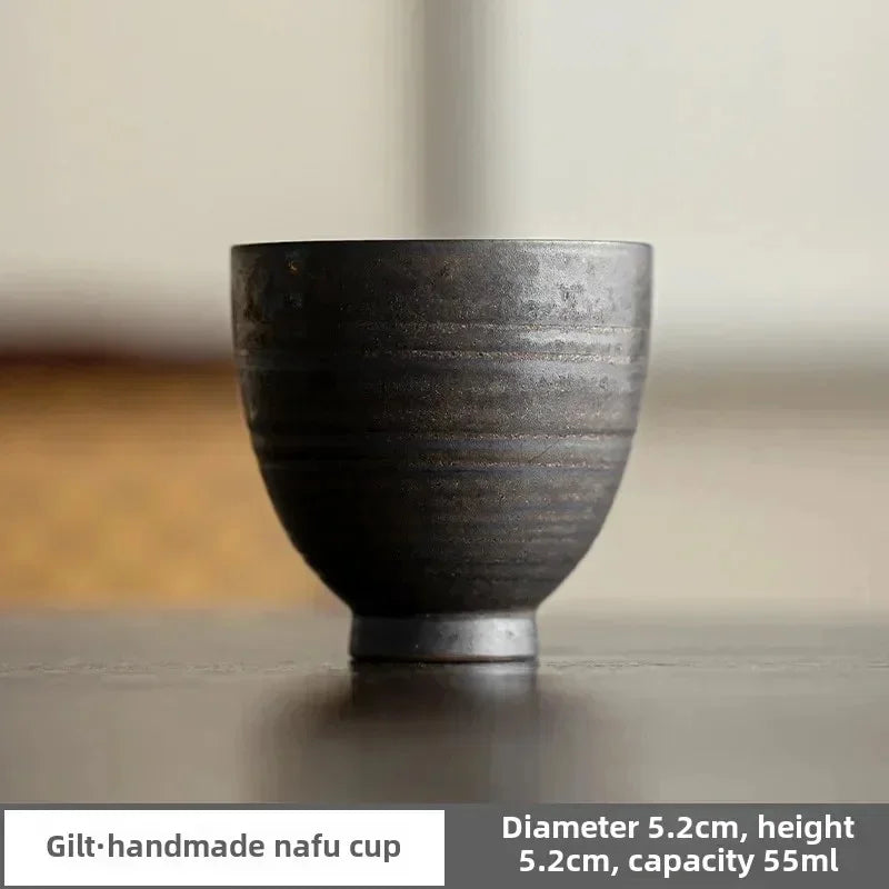 Handmade ceramic cup on a neutral background