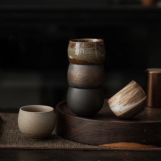 Stacked ceramic bowls on a wooden tray with a dark background