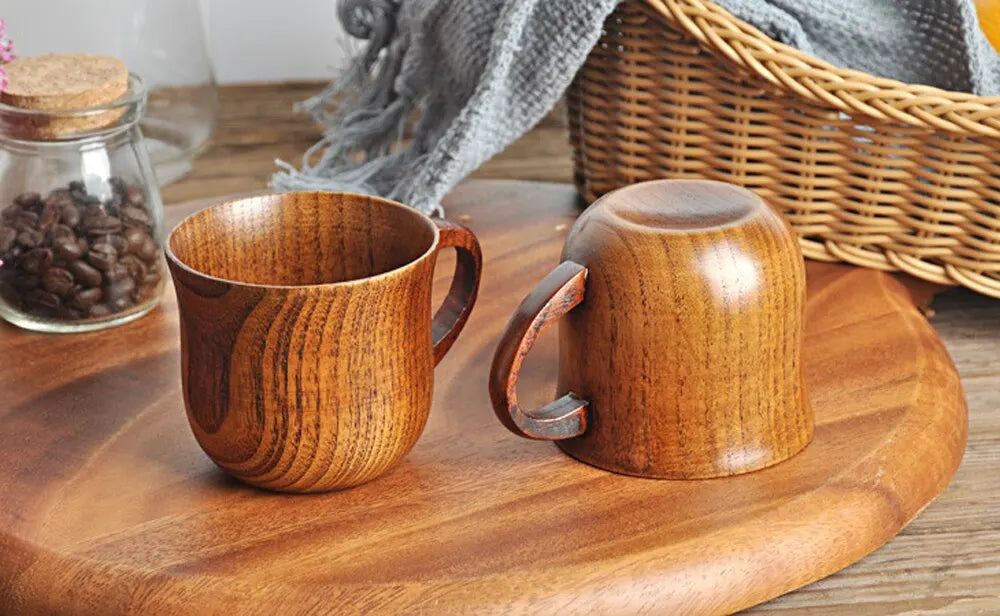 EcoNest 130ml Eco-Friendly Solid Wood Cup with Handle featuring tea inside on a rustic wooden table.