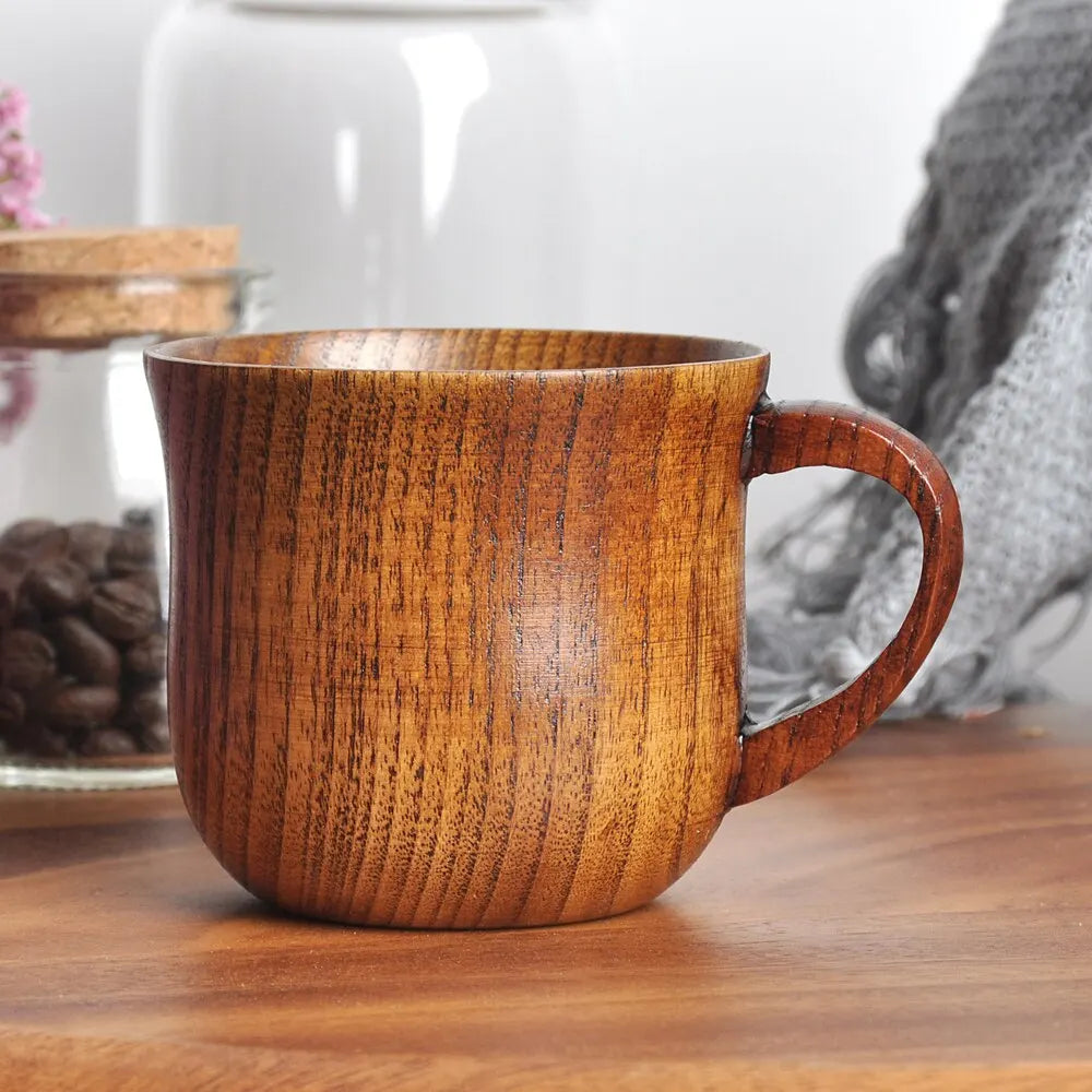 EcoNest 130ml Eco-Friendly Solid Wood Cup with Handle featuring tea inside on a rustic wooden table.