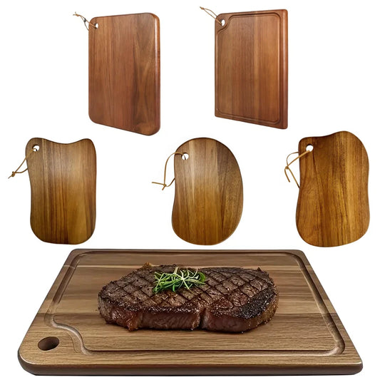 Set of wooden cutting boards with a steak on one board.