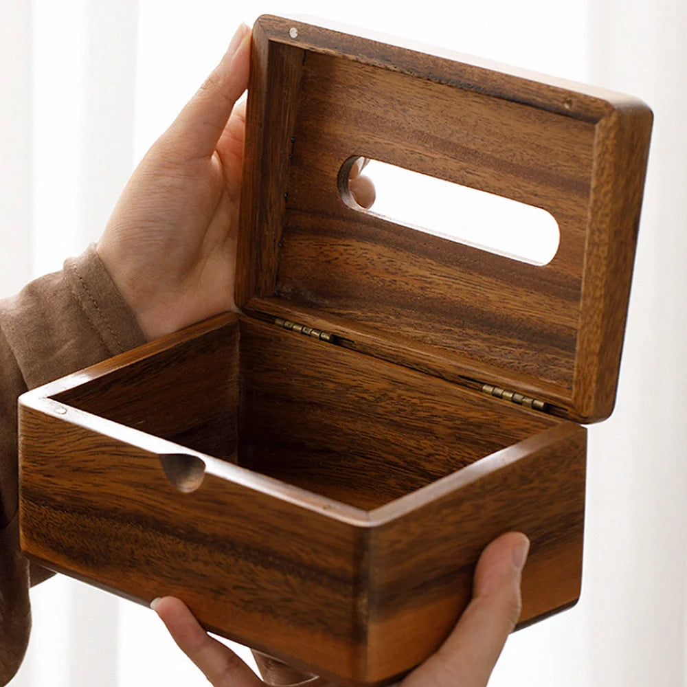Wooden tissue box held by a hand with a white background