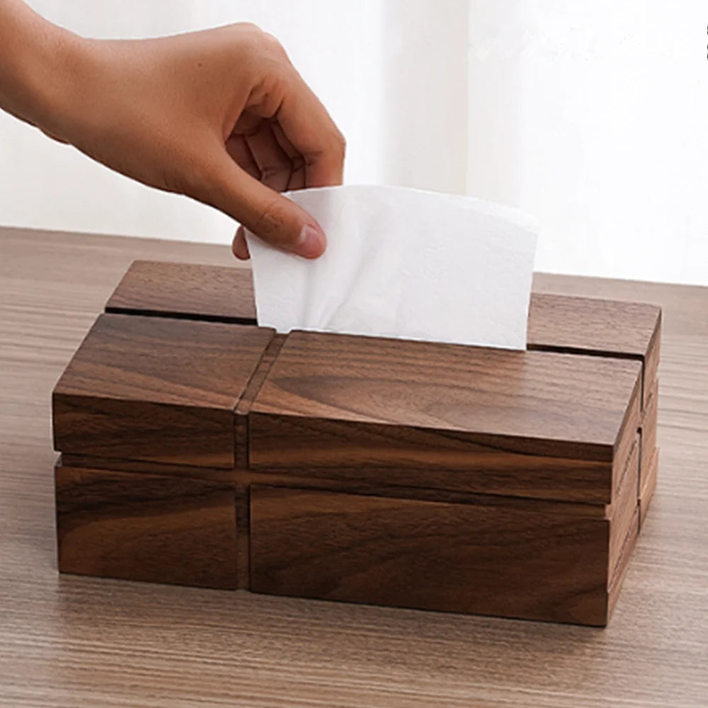 Wooden tissue box with a hand pulling out a white tissue.