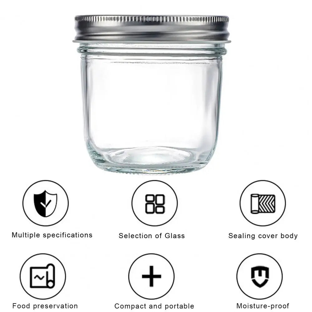 Clear glass jar with metal lid on a white background, featuring icons and text about product features.