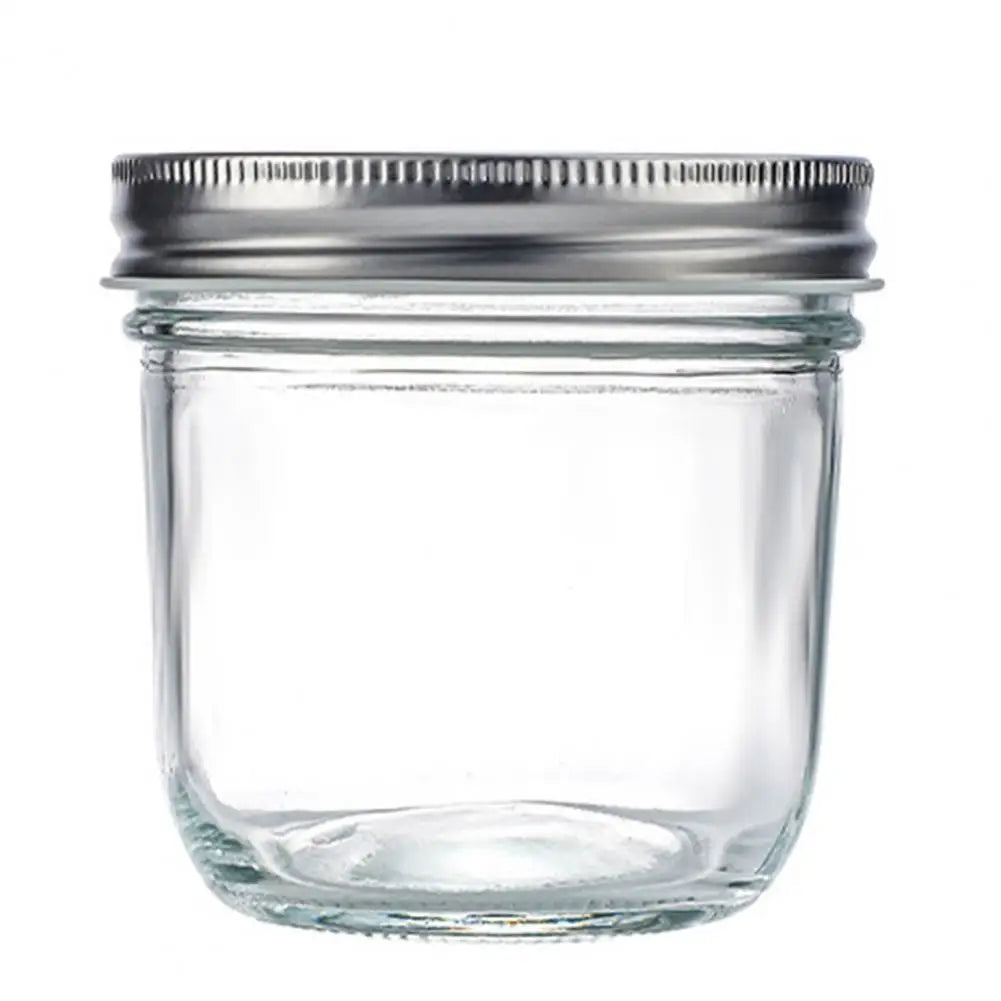 Clear glass jar with a metal lid on a white background