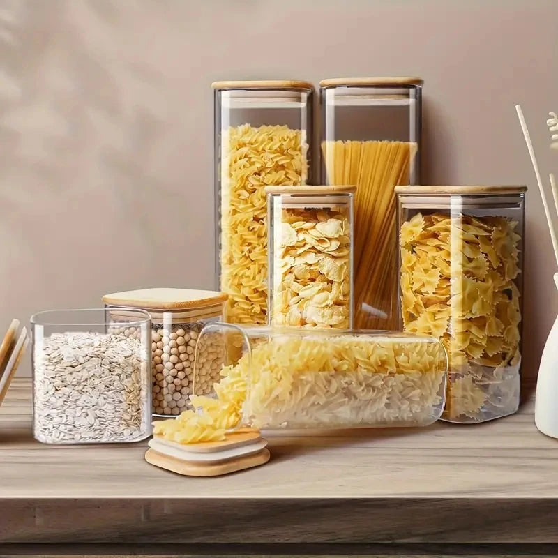 Stackable glass food storage jars with bamboo lids, sealed, transparent square containers for kitchen pantry and counter organization.