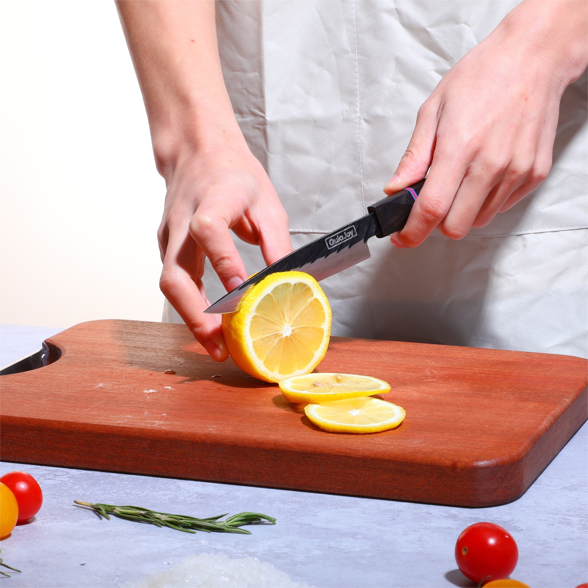 Person slicing a lemon on a wooden cutting board with a white background