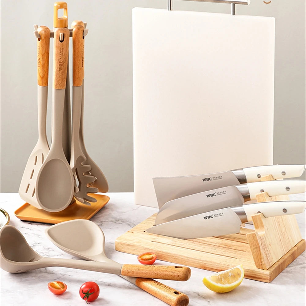 EcoNest Kitchen 4-Piece Silicone Spatula Set with Wooden Handles displayed with utensils and knives on a kitchen countertop.