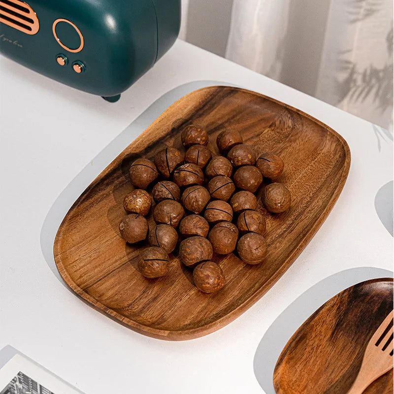 Wooden plate with nuts on a white surface