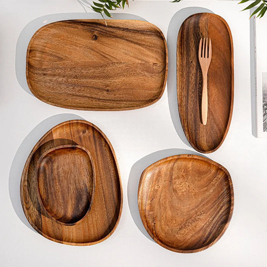 Set of wooden trays and a fork on a white background