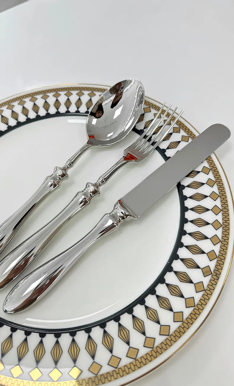 Stainless steel knife, fork, and spoon set by EcoNest Kitchen displayed on eco-conscious table setting