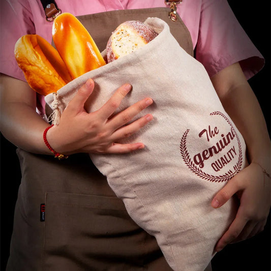 EcoNest reusable linen bread bag with drawstring, holding artisan bread on kitchen counter