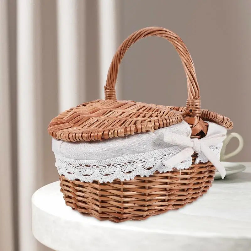 Wicker basket with a lid on a white surface, containing a white cloth and lace trim.
