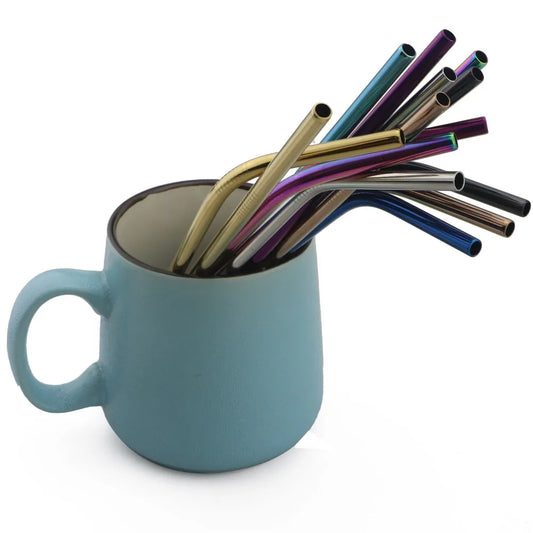 Blue mug filled with colorful metal straws on a white background