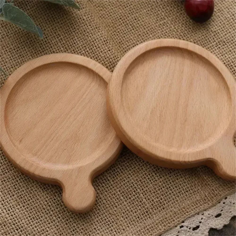 Two wooden coasters with handles on a textured fabric background